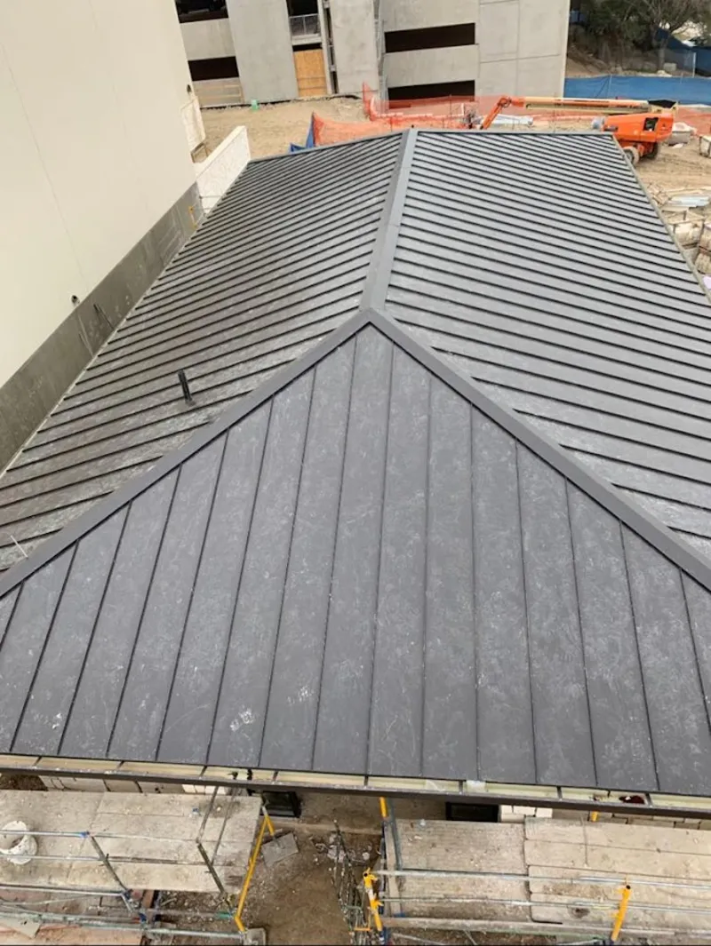 Commercial metal roof construction with crane equipment in Lucas Valley-Marinwood